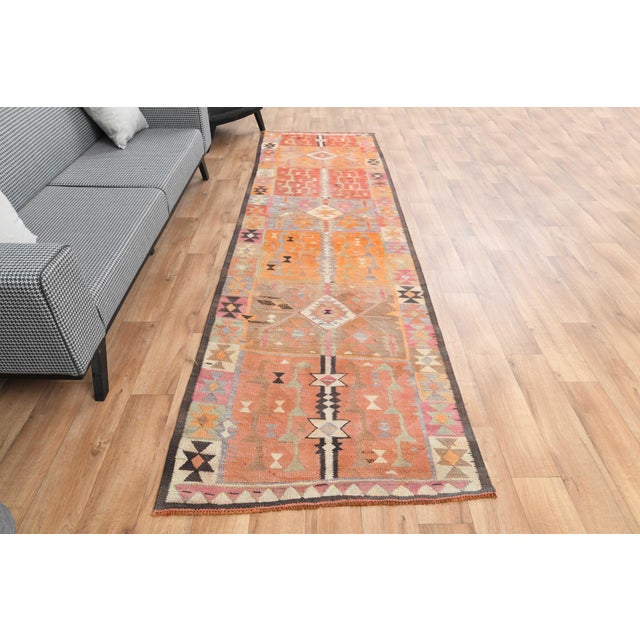 Vintage Hand-Knotted runner rug is a semi-antique vintage area rug. The '70s Eastern region of Anatolia's unique rug is...