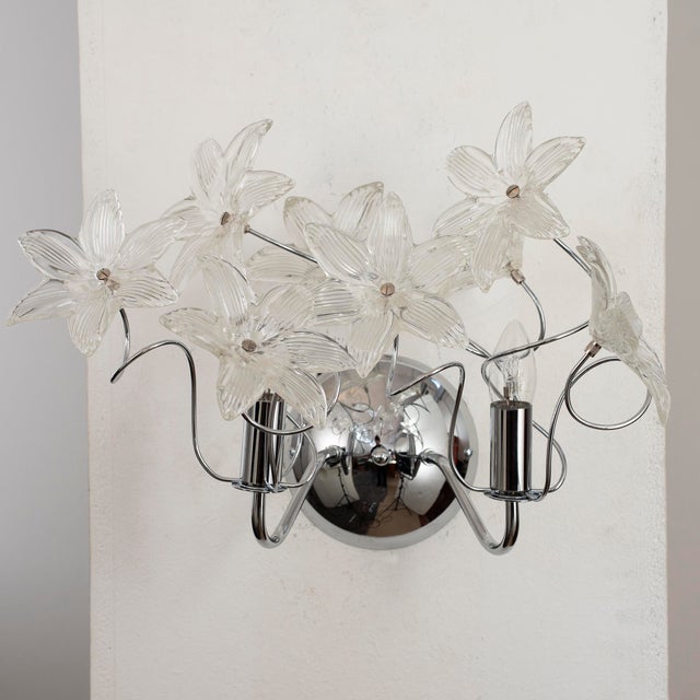 Applique with clear flowers in murano glass with chrome structure, wall lamp made in italy dimensions: w 50 cm x h 35 cm x...