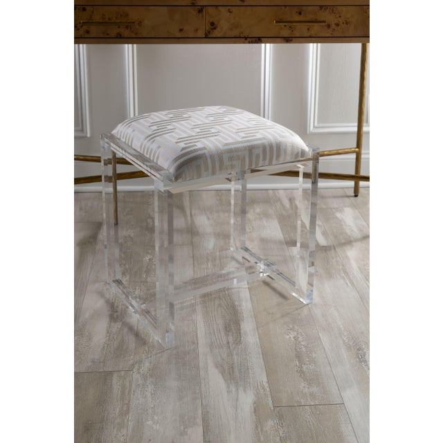 Glencoe is our clear lucite bench which we offer in fabric called Paros Key + an assortment of additional fabrics. The...