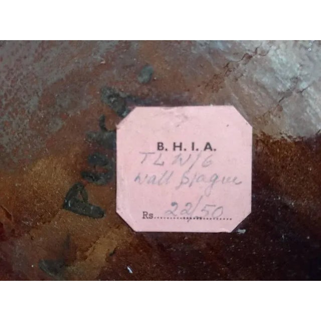 Irregularly shaped bowl depicting an exotic beauty. Marked on the back in the glaze TAKA-PUKA and on a sticker attached to...