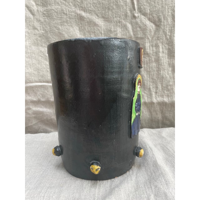 A striking mid-century Italian studio ceramic vase featuring applied relief figures and distinctive rounded accents. This...