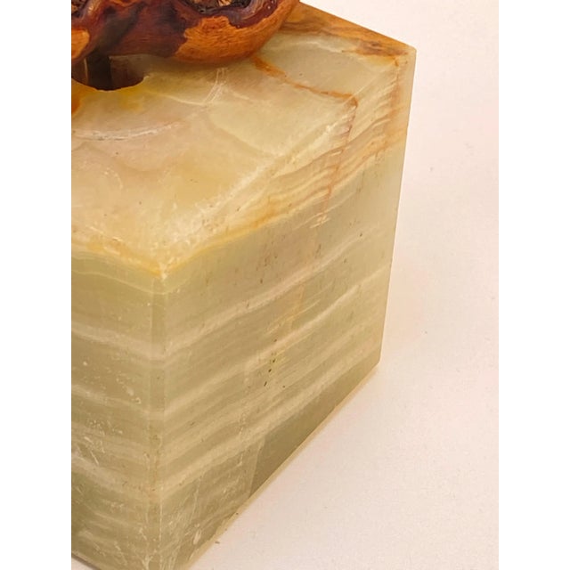 This Corkscrew is in wood and Onyx. The utensil is made of wood and iron, and it sits in its onyx base. The colors are...