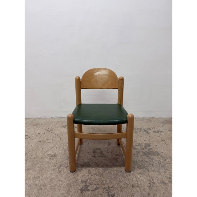 Single Padova side chair with a green naugahyde seat on an oak wood frame designed by Hank Loewenstein. Chair is in...
