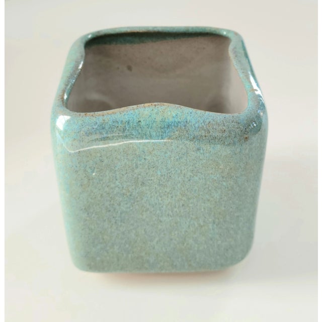 This is a ceramic turquoise speckle planter by Parker Glidden. This piece was made in America, c.1940-1957.