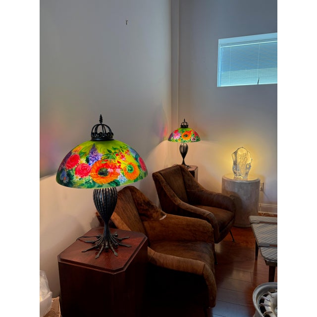 Matching pair of signed Ulla Darni original table lamps. Each glass shade is reverse painted on glass and signed Ulla. The...