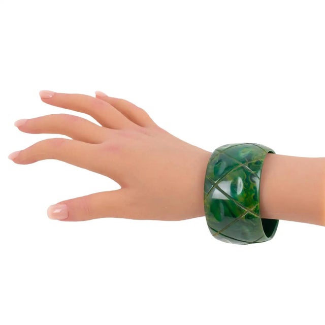 This is a stunning green bluemoon marble Bakelite carved bracelet. The bangle features a chunky, oversized, domed shape...