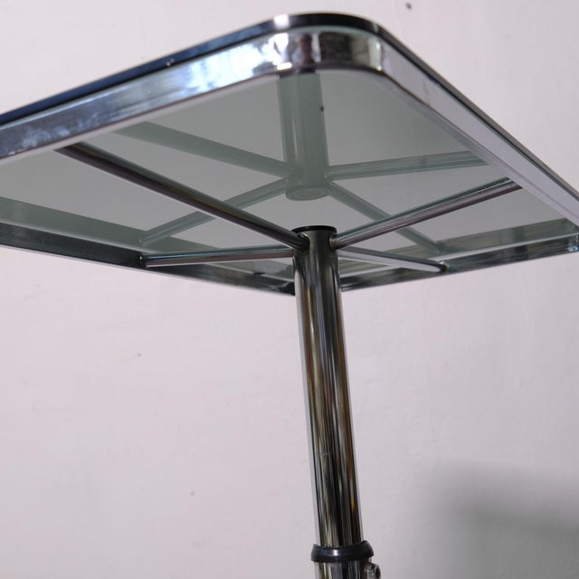 This is an iconic height-adjustable coffee table from the 1970s designed by Allegri Parma, featuring a chromed steel frame...
