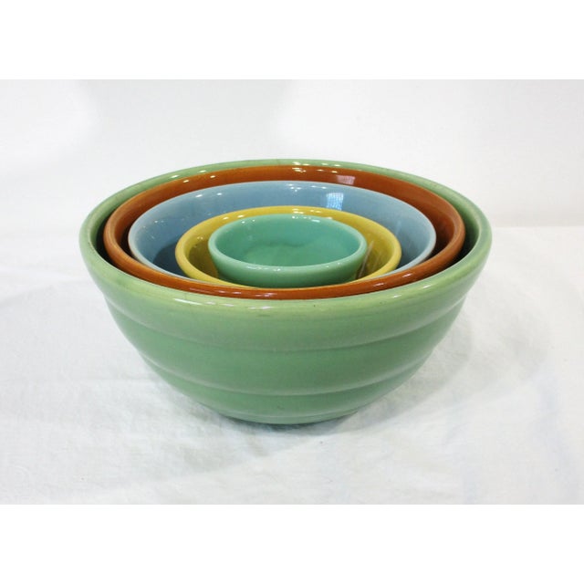 A vintage five-piece colorful California pottery mixing or serving bowl set manufactured by the Bauer Pottery company Los...