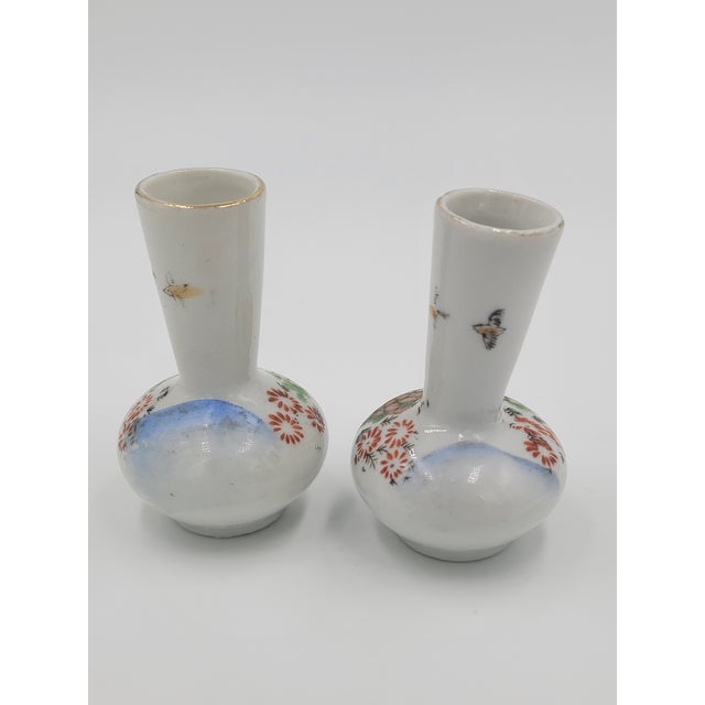Add a touch of delicate mid-century artistry to your bookshelf or vanity with this exquisite pair of miniature porcelain...