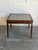This square side table features a vibrant geometric ceramic tile top inlaid within a rich rosewood frame. Its clean...