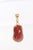 A lovely coral pendant with 21 karat gold trim and mobile bail. The surface of the coral is highly polished and smooth,...