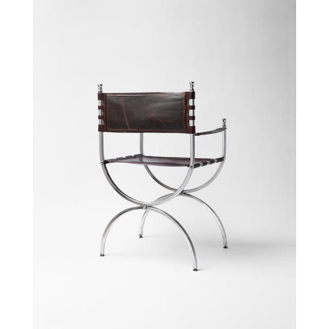 This chair is a refined example of French Mid Century design, drawing on the historic Savonarola, or curule, X frame form,...