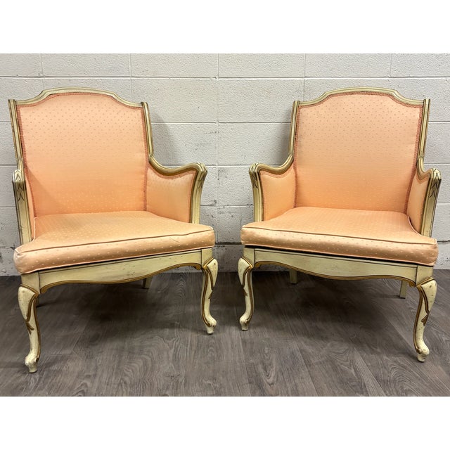 This is a gorgeous pair of vintage French Louis XV style Bergere lounge armchairs. They feature painted cream frames with...