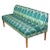 A teal and turquoise ikat upholstered banqette adds a happy punch of color to a room. The chic bench seating in vibrant...