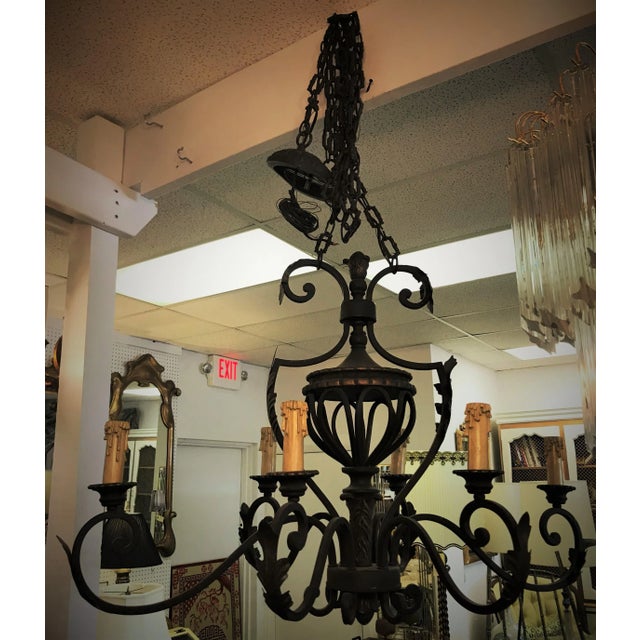 Large and elaborate iron chandelier. It has a double adjustable chain to the ceiling box which makes it slightly wider in...