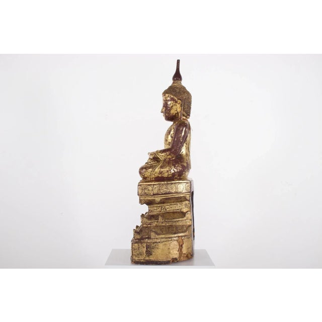 Imposing carved wooden Maravijaya Buddha, covered in wine-red lacquer and gilding. Burma (Myanmar), Shan principalities,...