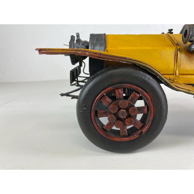 This is a mid century vintage antique automobile model. This handmade model has its original mustard yellow paint with...