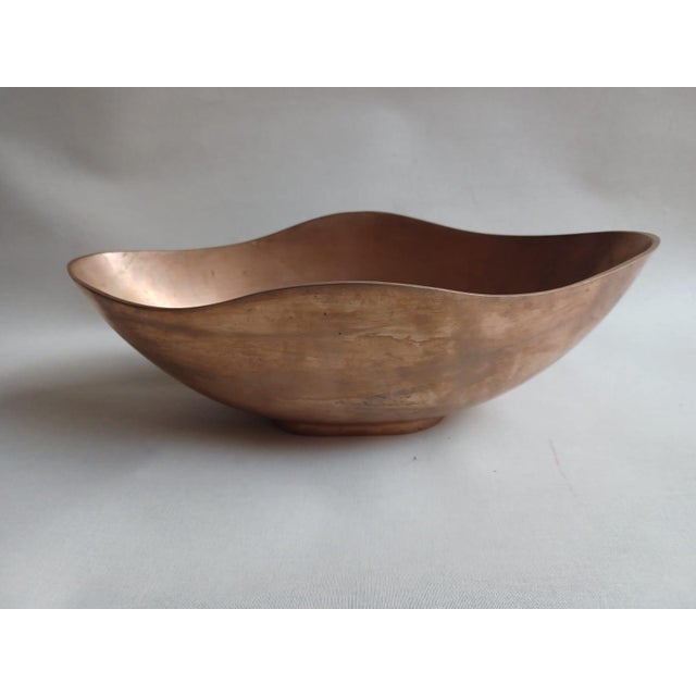 Esa Fedrigolli’s cast bronze sculptural bowl, measuring 38 x 19 cm with a height of 13 cm and weighing 4 kg, stands out...