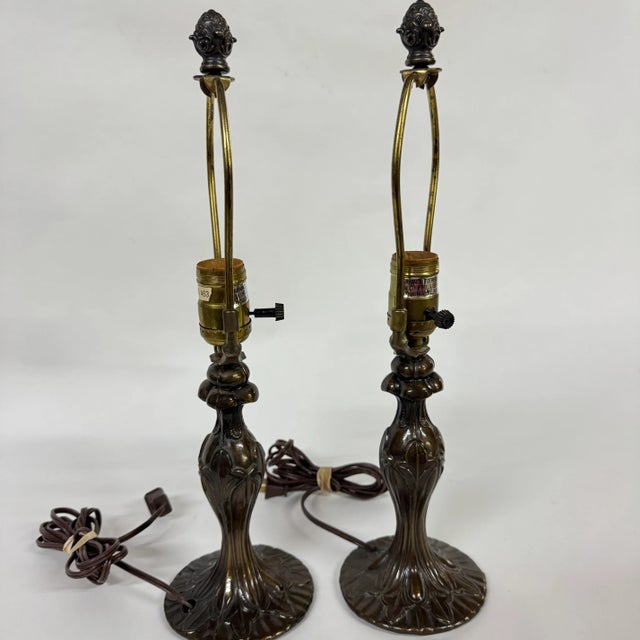 Pair of reproduction Art Nouveau style lamps made from metal with a patinated bronze finish. Both lamps are in working...