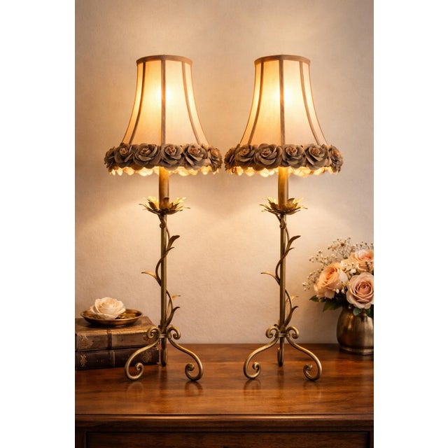 Elegant vintage Hollywood Regency table lamp pair crafted in gilt tole metal with sculptural vine and leaf motif bases....