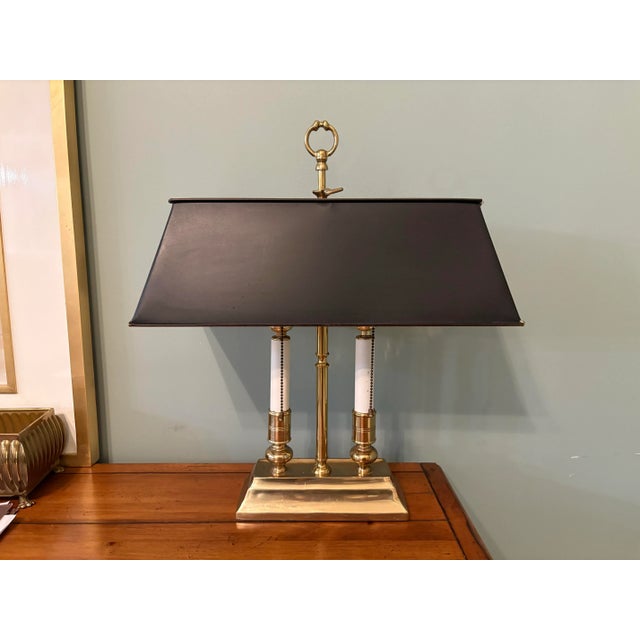 Late 20th Century Traditional brass bouillotte lamp in the style of Chapman, Stifle and Wildwood. This timeless classic...