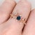 An AAA London blue topaz glows in a deep, steely blue at the centre of this solid 14K rose gold ring, surrounded by twelve...