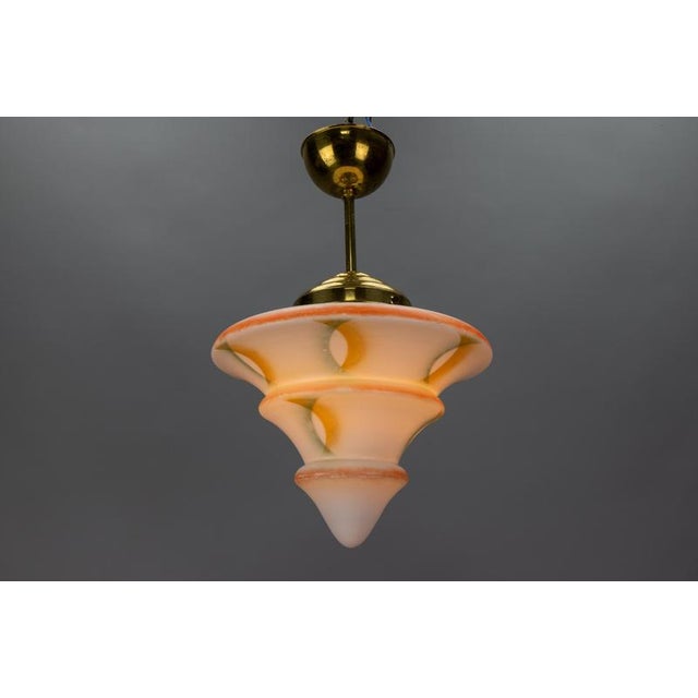 This stunning Art Deco pendant light, crafted in Germany in the 1930s, features an elegant, beautifully shaped white glass...