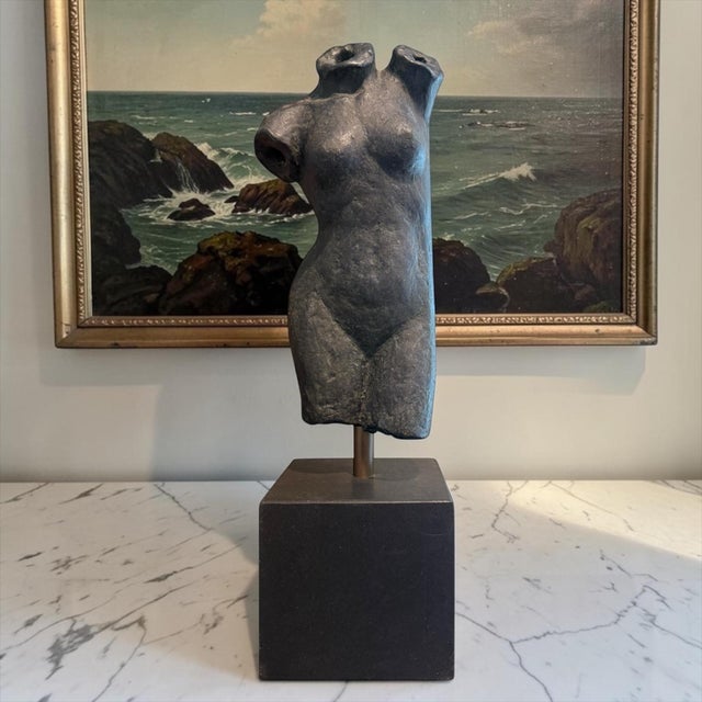 An evocative modernist bronze female torso sculpture mounted on a substantial plinth base. Rendered with a richly textured...