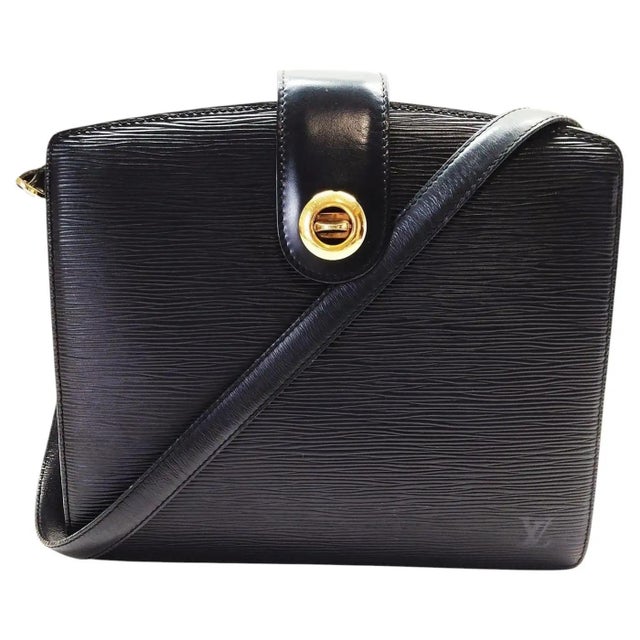 This stunning vintage Louis Vuitton Capucines shoulder bag, crafted in the house's iconic black Epi leather, perfectly...