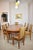 An exceptional André Sornay dining ensemble from the 1930s: an extendable walnut table paired with eight matching chairs,...