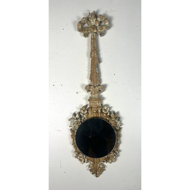 19th C. French ornate wall mirror with a distinctive antique style. The mirror has a round shape, encased in a highly...