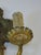 The product is a medium-sized Wall Sconce Electric in an elegant bronze Empire style, featuring an embossed pattern...
