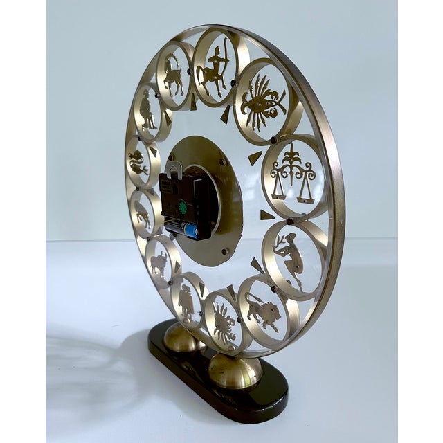 Very large Zodiac Theme Clock from the 1950s featuring a bakelite base, brass dial with cut out zodiac signs, center...