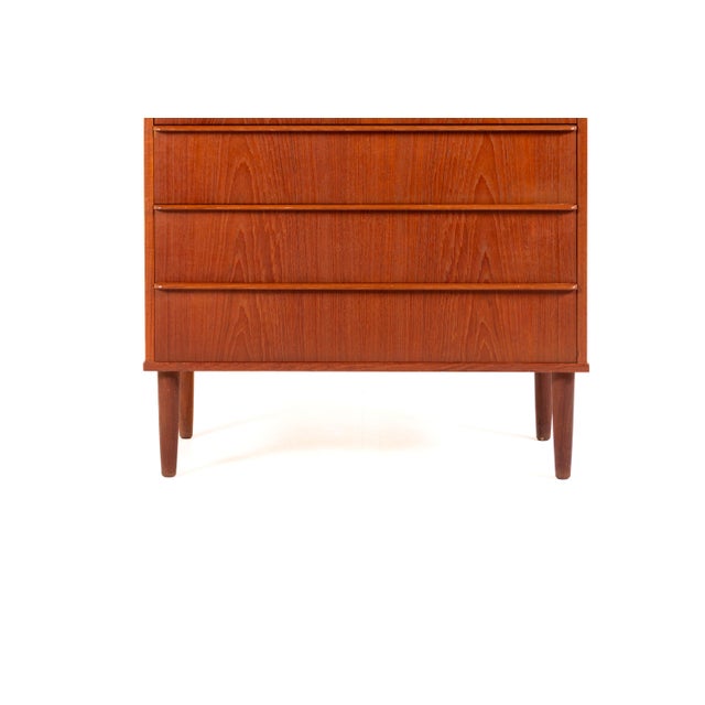 A classic Danish tallboy chest from the 1960s, made by Si-bomi Møbler and crafted in warm teak with a beautiful natural...
