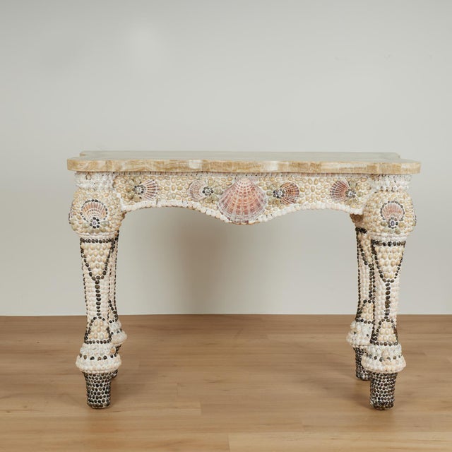 Impressive grotto style Italian console table featuring a scalloped marble veneer top over a classical form base with...