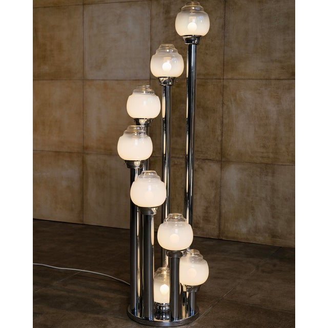 Eight hand-blown Murano glass globes appear to cascade from polished chrome columns of varying heights, giving this...