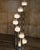 Eight hand-blown Murano glass globes appear to cascade from polished chrome columns of varying heights, giving this...