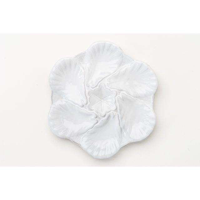 The newest addition to our classic Fleur de Lis collection is a stark white ceramic oyster plate. Perfect for serving...