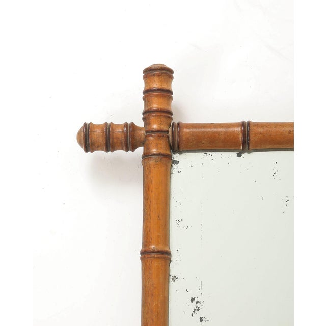 This charming 1940s English mirror features a finely carved faux bamboo frame with a rich, warm patina that beautifully...