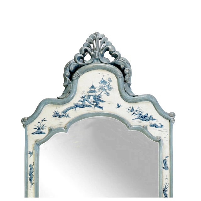 This mirror blends Rococo silhouettes with Chinoiserie design elements. The ornately carved wooden frame is topped with...