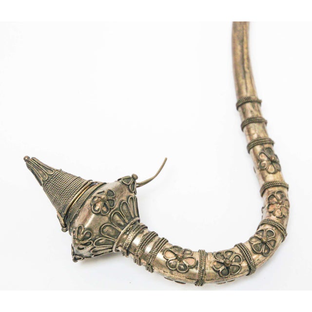 Asian metal opium pipe with filigree art work in floral designs. Silvered metal alloy, patinated could be cleaned to be...