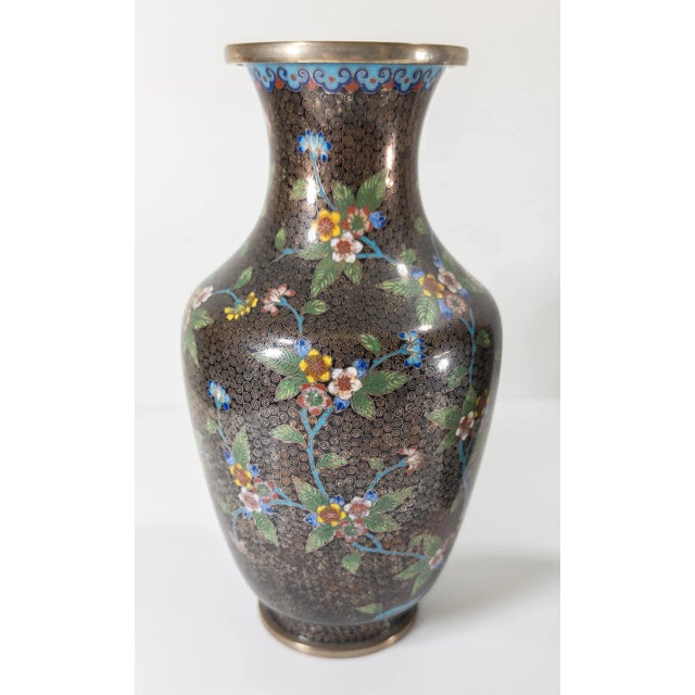 We are selling this very pretty pair of Chinese cloisonne vases. These vases have silver plated appearance with floral...