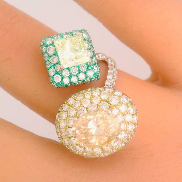 A super cool and unique diamond ring! It features an oval-shape diamond weighing 2.02 carats and a princess-cut diamond...