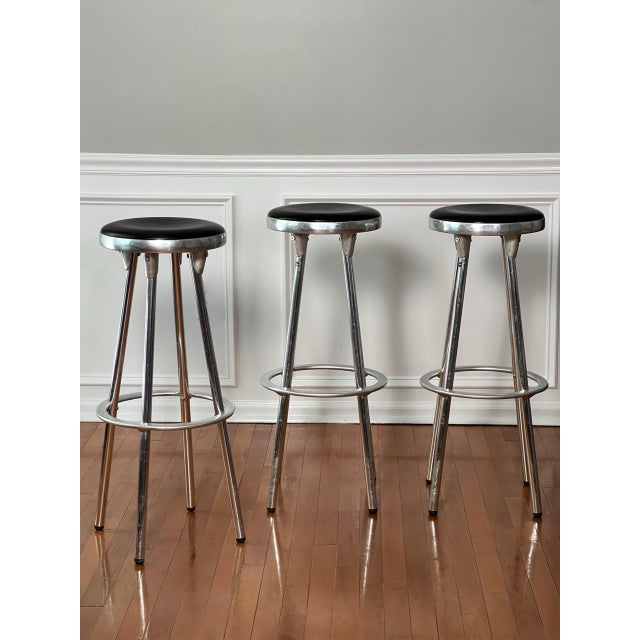 Set of three industrial aluminum bar stools by Joan Casas i Ortinez for Indecasa, Barcelona, Spain, 1980s. Ultra sleek set...