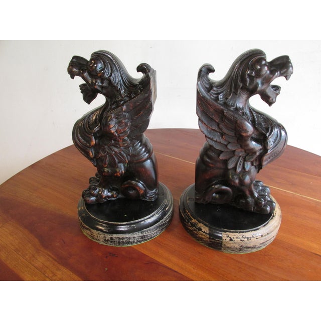 Pair Mid 19th Century English intricately carved wooden griffins. Likely architectural trim originating from an English...
