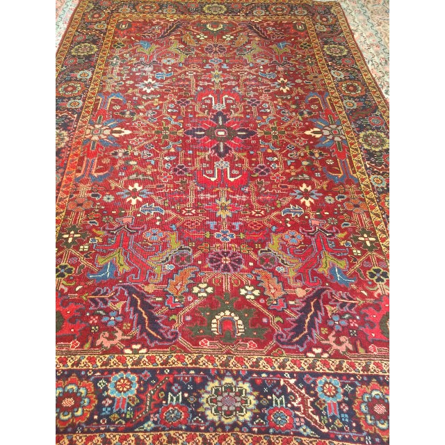 "An extraordinary and rare early 20th century Persian Heriz Serapi rug featuring a vibrant allover geometric design that...
