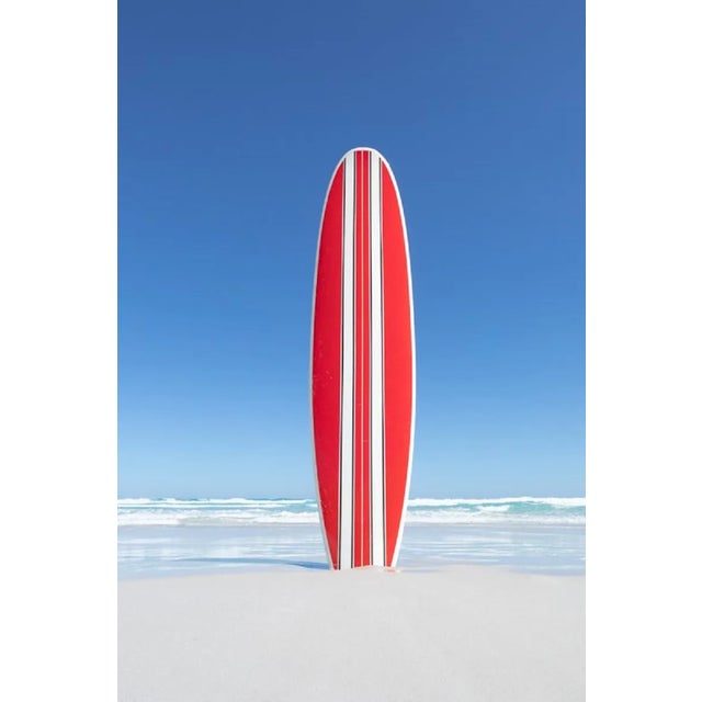 John White, Red and White Striped Retro Surfboard with the Ocean in the Background, Photographic Paper For Sale