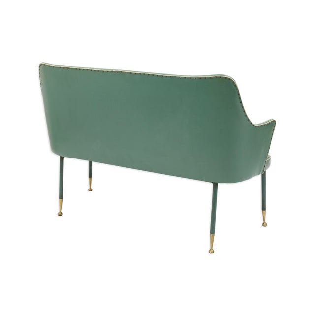This vintage green vinyl two-seat bench offers a sleek mid-century look with a touch of character. The smooth vinyl...