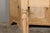 An English bleached oak side table from the 19th century with slightly raised back, single drawer carved with a shield in...