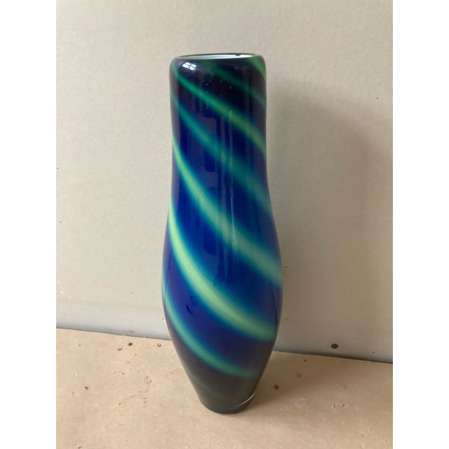 Mid-Century Eastern Blue swirl hand blown vase. Vase measures 15 inches high and 6 inches at the widest point and 2.5...
